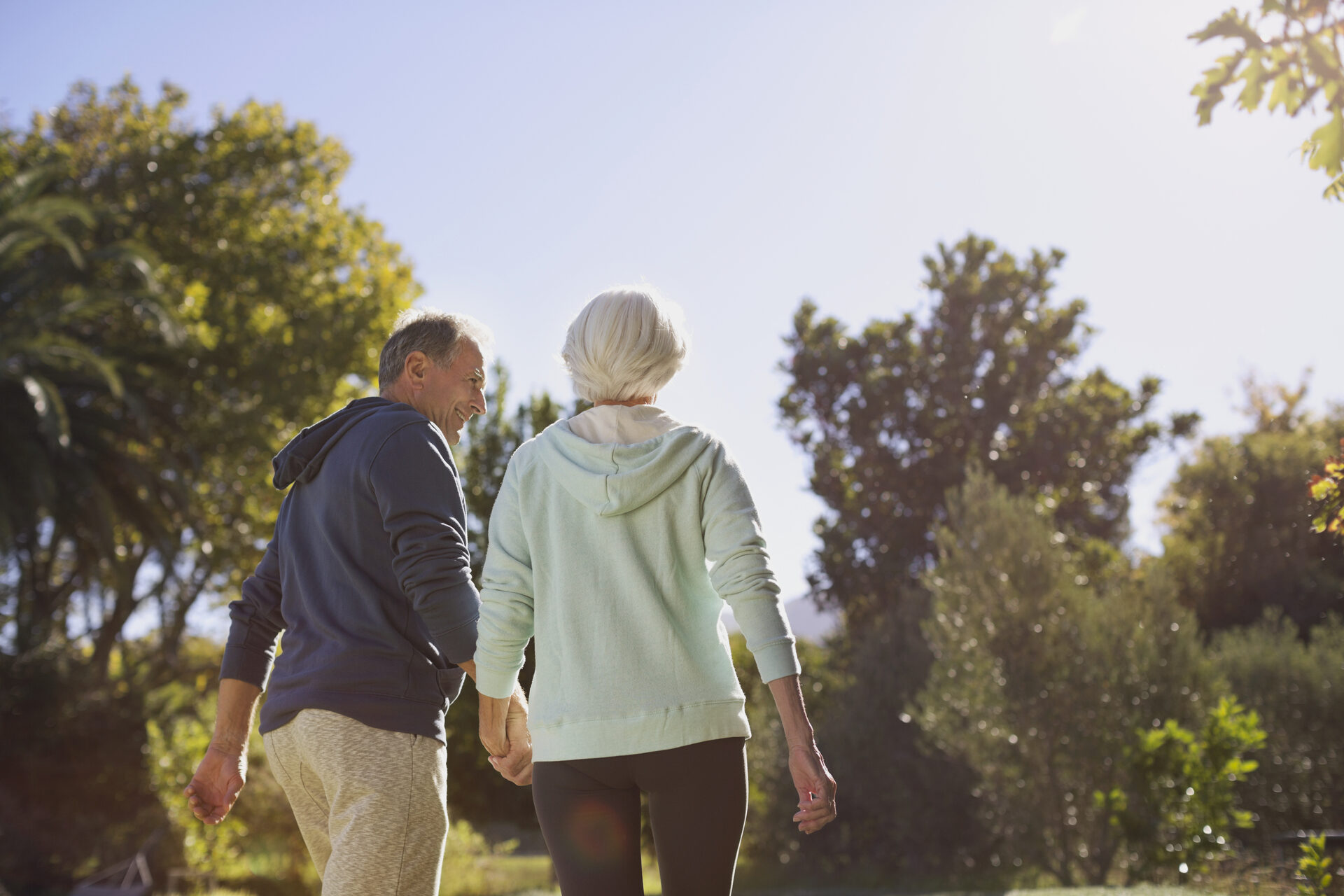 Older couple being supported by a physiotherapist